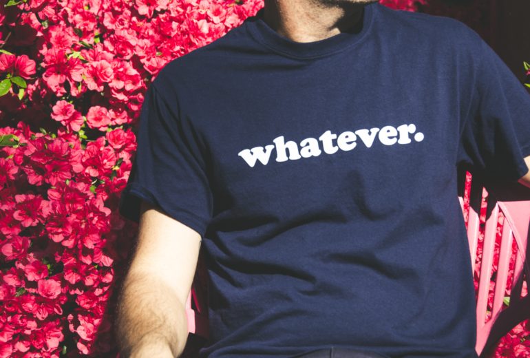man wearing shirt with 'whatever' on it